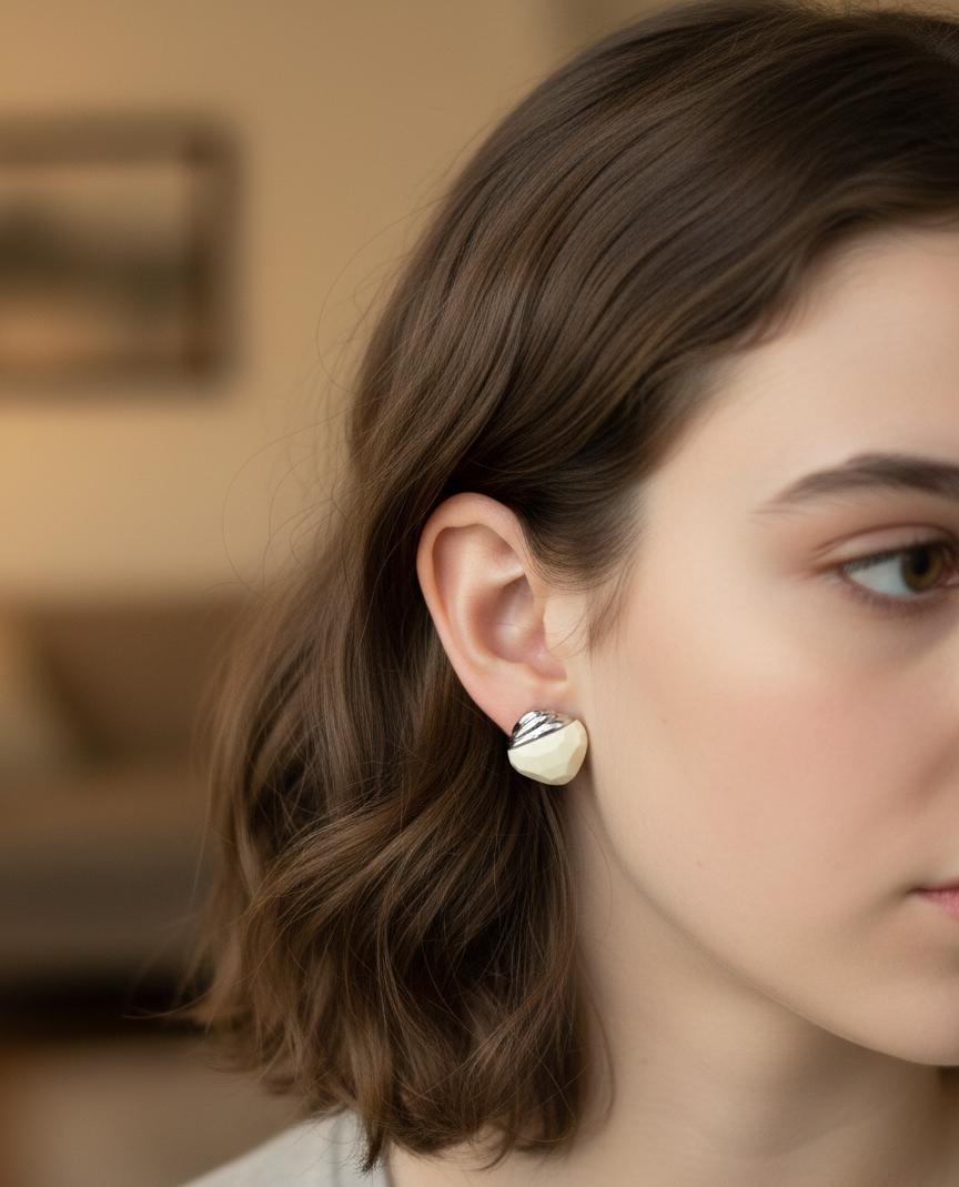"Geometric Faceted Ivory Stud Earrings with Silver Swirl Accent"